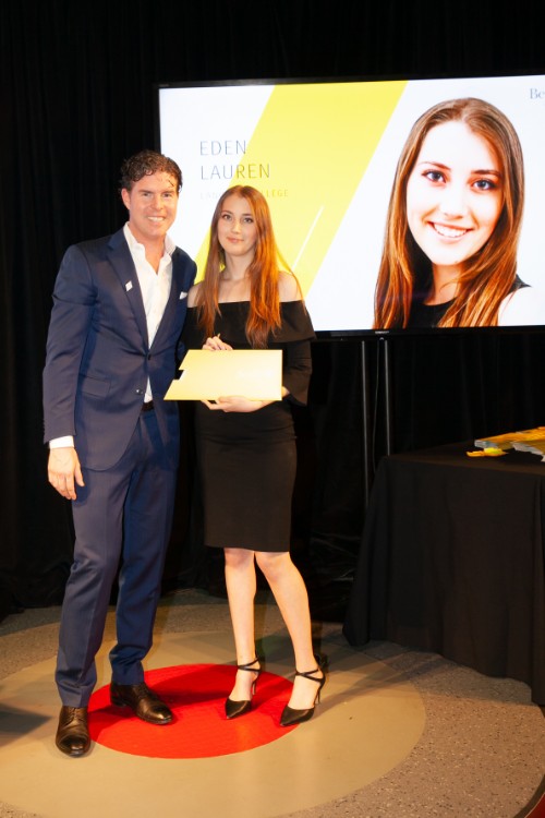 Ryan Beedie (left), standing next to Eden Lauren (right), holding a yellow certificate.