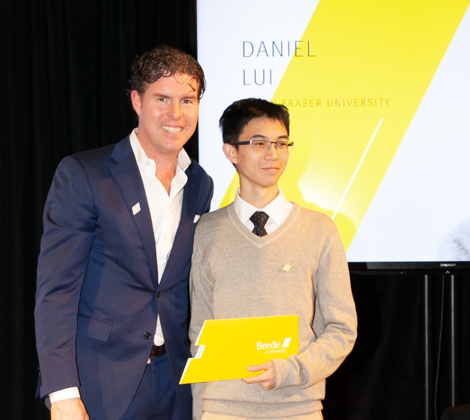 Ryan Beedie (left), standing next to Daniel Liu (right), holding a yellow certificate.