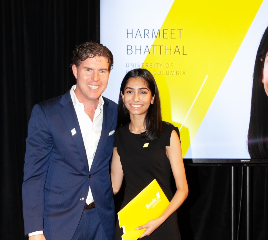 Ryan Beedie (left), standing next to Harmeet Bhatthal (right), holding a yellow certificate.