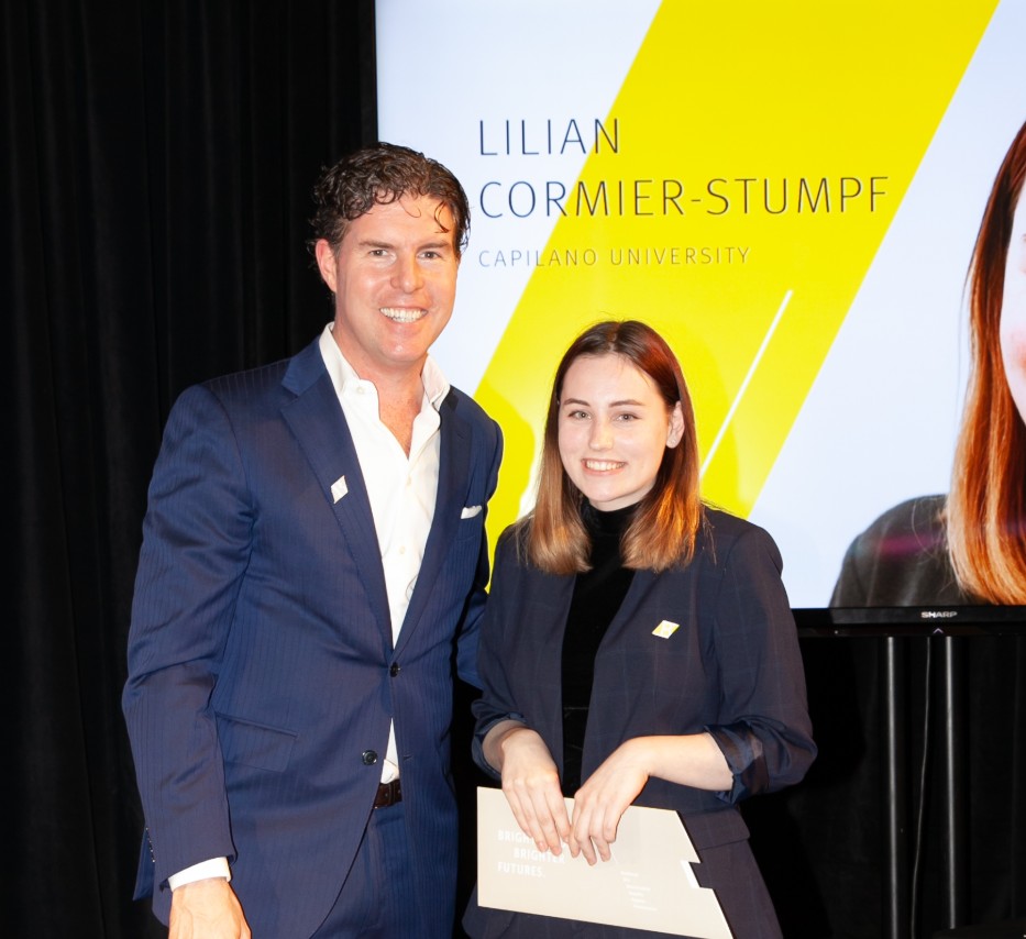 Ryan Beedie (left), standing next to Lilian Cormier-Stumpf (right), holding a yellow certificate.