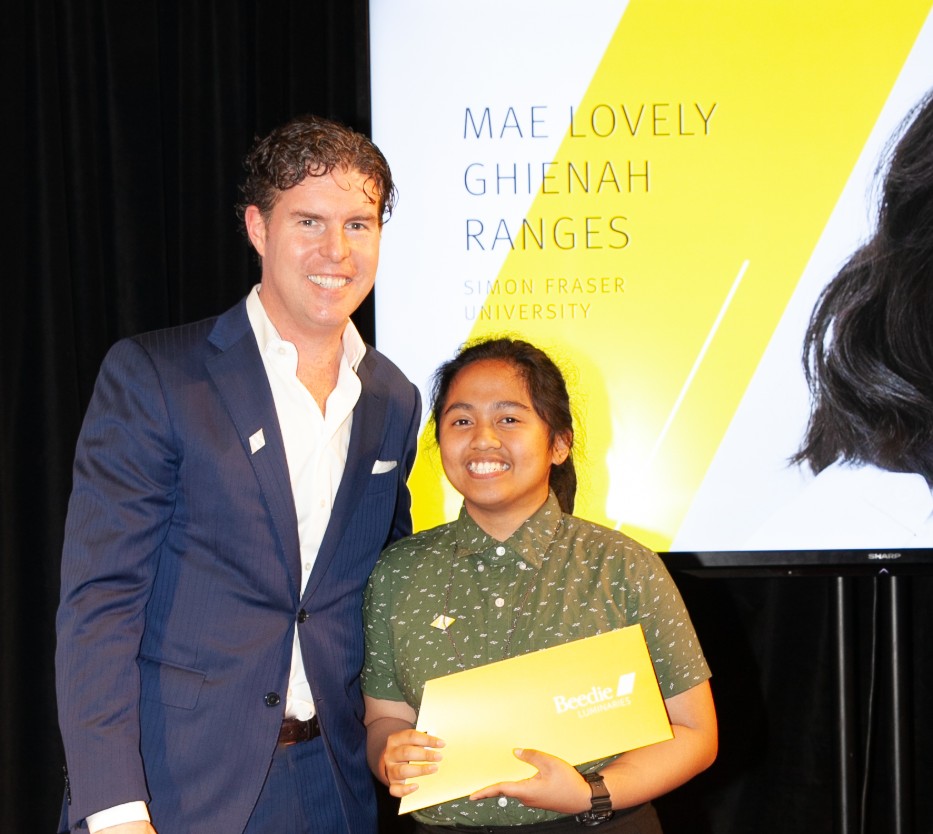 Ryan Beedie (left), standing next to Mae Lovely Ranges (right), holding a yellow certificate.