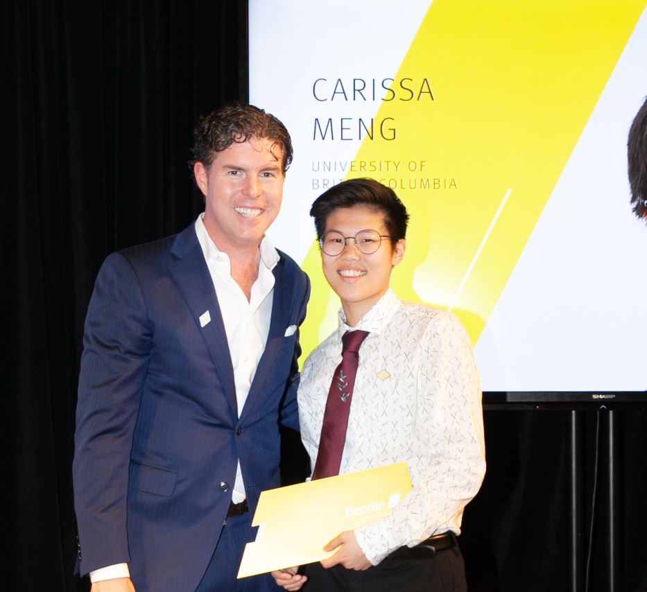 Ryan Beedie (left), standing next to Clay Meng (right), holding a yellow certificate.