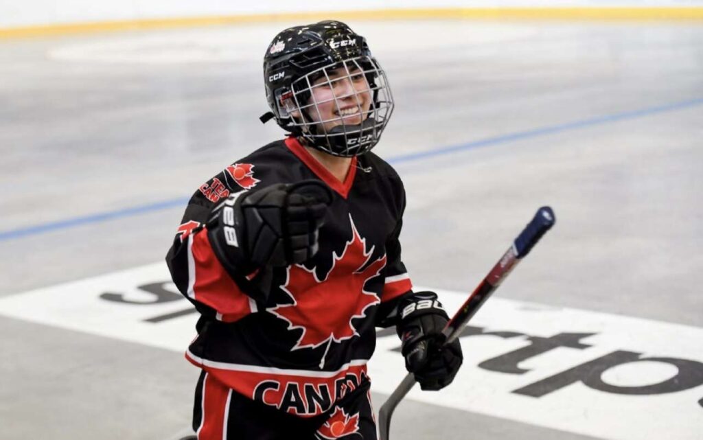 Maggie captured candidly smiling in her Team Canada Ball Hockey uniform, while holding her stick.