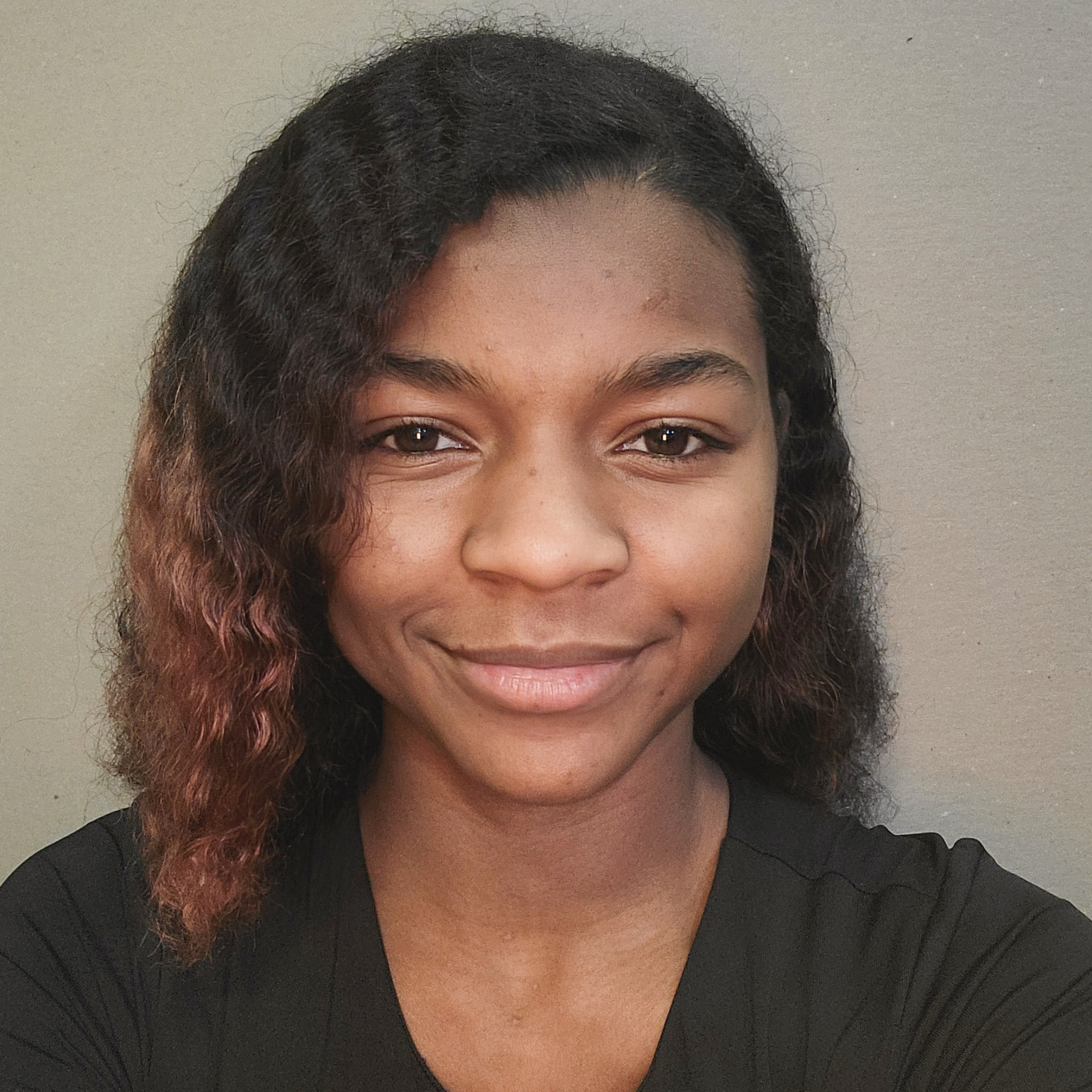 Tia Findlater smiles for a selfie, wearing a black shirt.
